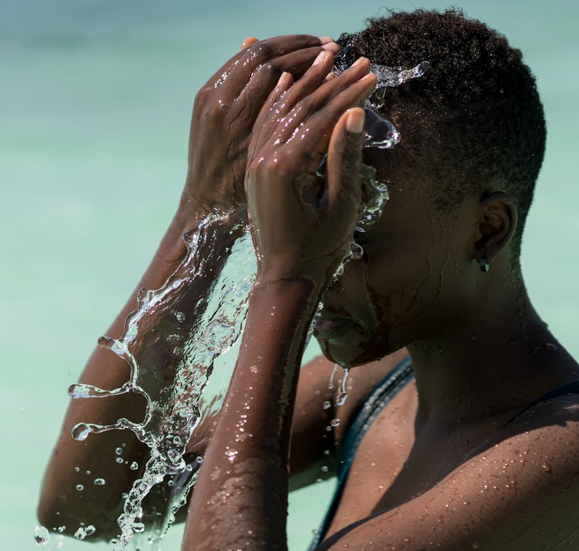 Black skin girl in turquoise water