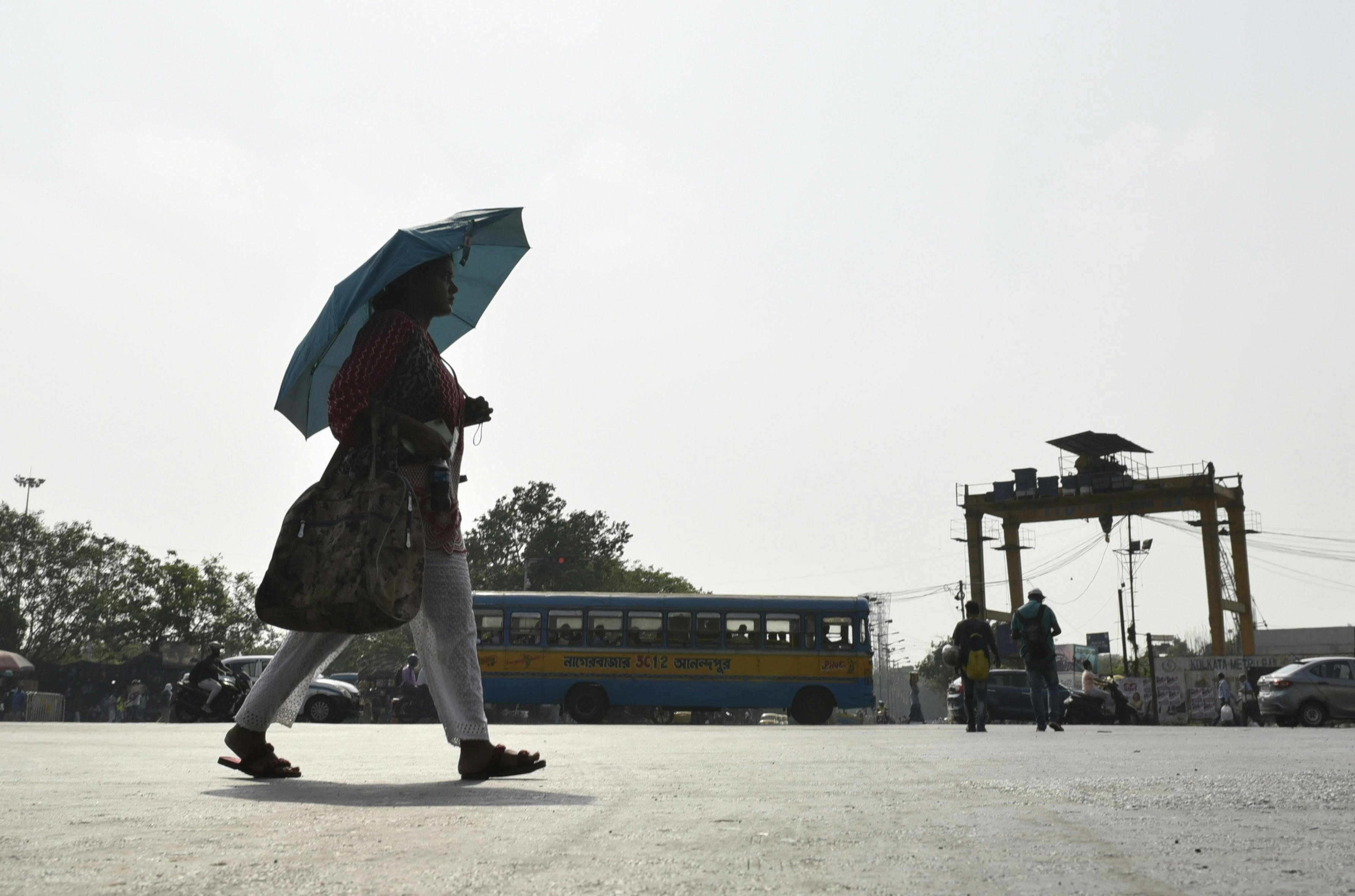 A woman carry an umbrella amid heatwave in Kolkata, India, 29 April, 2022.  (Photo by Indranil Adity...
