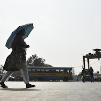 A woman carry an umbrella amid heatwave in Kolkata, India, 29 April, 2022.  (Photo by Indranil Adity...