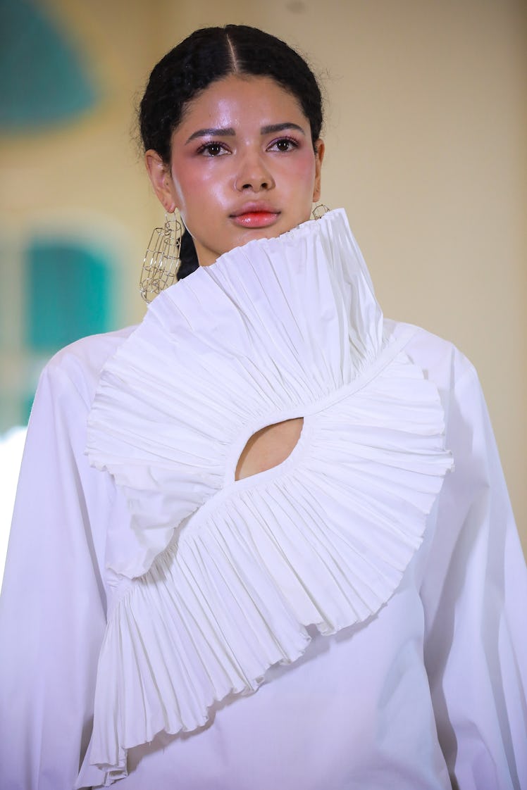 A model wearing lip gloss walks the runway during the Francisco Cancino show as part of the Mercedes...