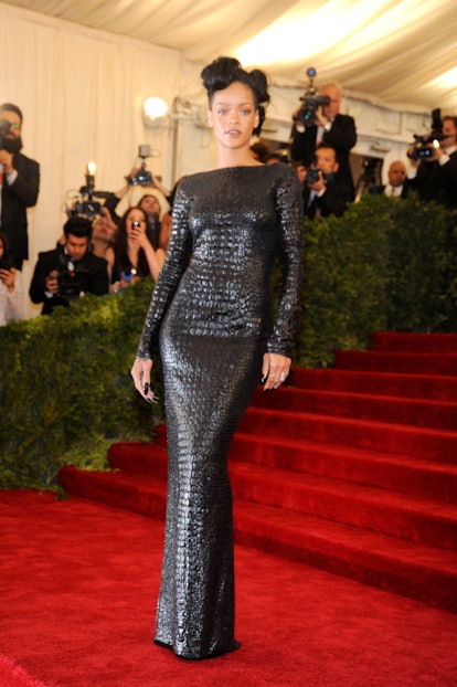 Rihanna attends the "Schiaparelli And Prada: Impossible Conversations" met gala in a black croc gown