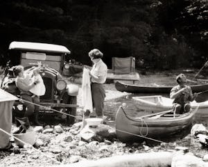 1920S Three Generation Family Traveling by Automobile Fishing And Rough Tent Camping On Rocky Stream...