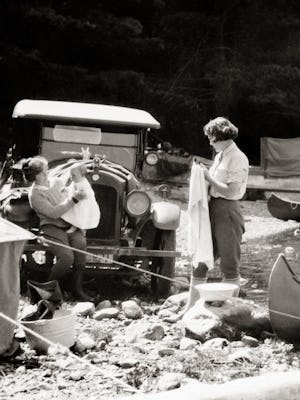 1920S Three Generation Family Traveling by Automobile Fishing And Rough Tent Camping On Rocky Stream...