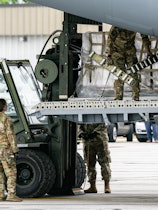 INDIANAPOLIS, IN - MAY 22: Airmen unload pallets from the cargo bay of a U.S. Air Force C-17 carryin...
