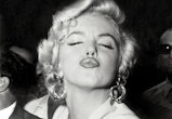 American actress Marilyn Monroe poses in front of the photographers, making a very graceful face, on...