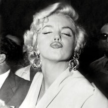 American actress Marilyn Monroe poses in front of the photographers, making a very graceful face, on...