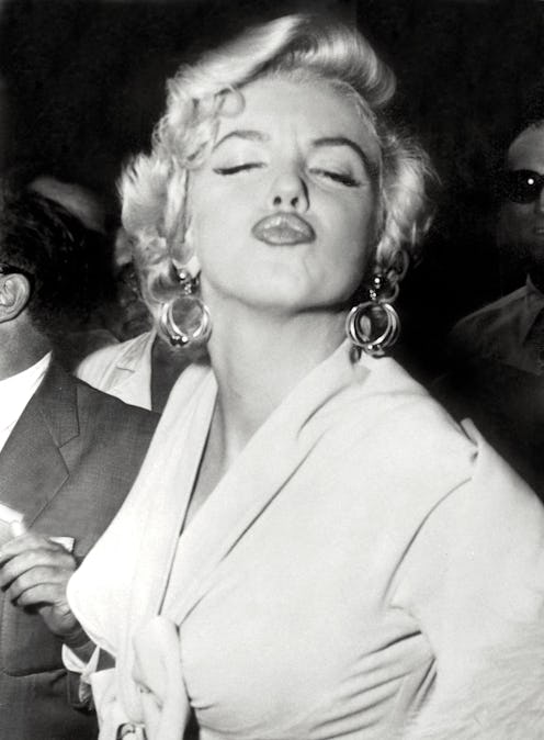 American actress Marilyn Monroe poses in front of the photographers, making a very graceful face, on...