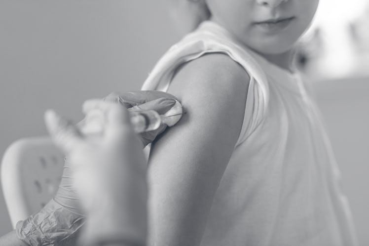 Doctor doing injection of vaccine to girl