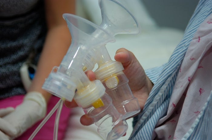 woman holding breast pump parts, Should you bring a breast pump to the hospital?