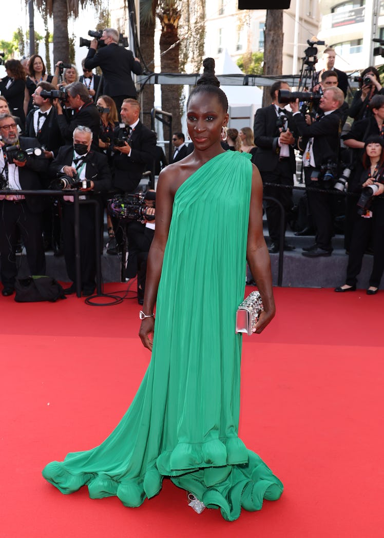Eye Haidara at the red carpet at the Cannes Film Festival 2022 in a long green gown and a silver bra...