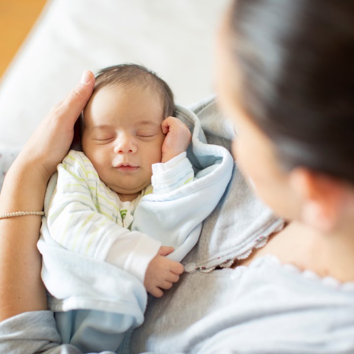 A mother cradling her newborn. According to a CDC report, the U.S. birth rate increased for the firs...