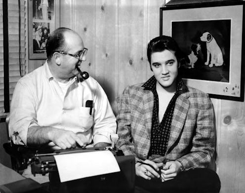MEMPHIS, TN - CIRCA 1956:  Singer Elvis Presley and his manager Colonel Tom Parker sit at a typewrit...