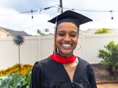 A woman smiles for her graduation, which she'll post about with high school graduation Instagram cap...