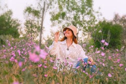 Woman sitting and enjoying nature in countryside. The May 2022 new moon in gemini will affect these ...