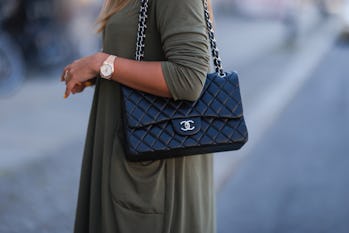 BERLIN, GERMANY - JUNE 16: Nina Suess wearing black Chanel leather flap bag and khaki Zara dress on ...