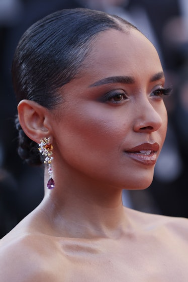 A closeup of Kat Graham at the screening of "Armageddon Time" at Cannes, wearing dangling earrings w...