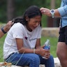 TOPSHOT - A girl cries, comforted by two adults, outside the Willie de Leon Civic Center where grief...