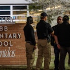 UVALDE, TEXAS - MAY 24: Law enforcement officers speak together outside of Robb Elementary School fo...