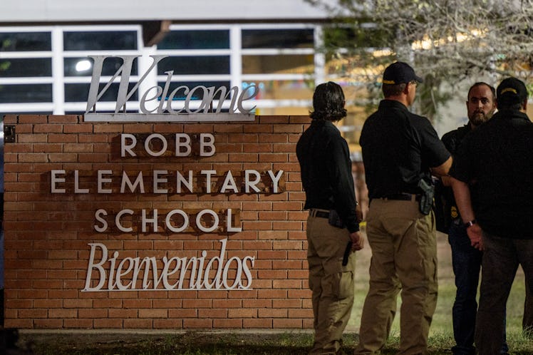 UVALDE, TEXAS - MAY 24: Law enforcement officers speak together outside of Robb Elementary School fo...