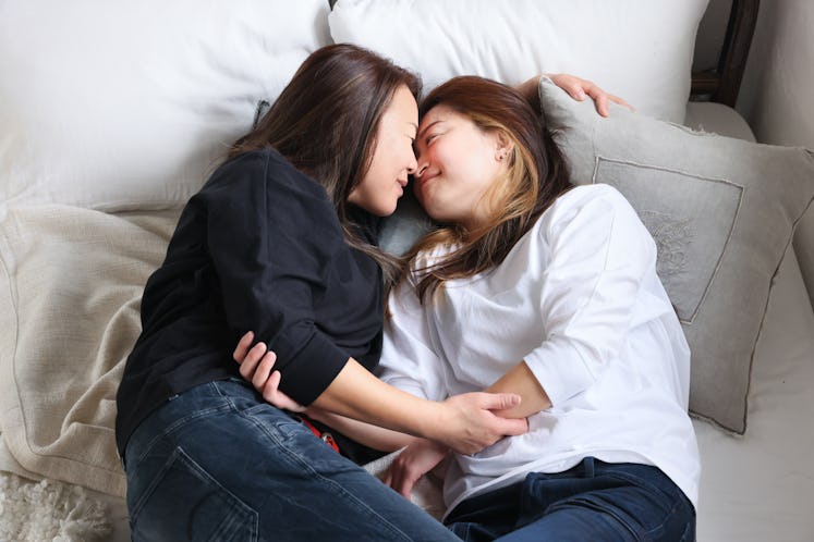 LGBTQ+ couple in bed kissing and exploring praise kink 