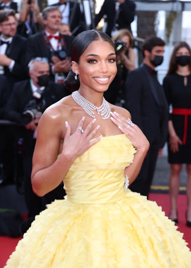 Lori Harvey at the screening of Final Cut and opening ceremony red carpet in Cannes in a yellow gown...