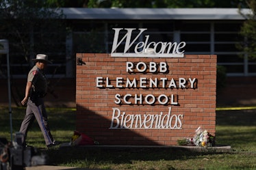 An officer walks outside of Robb Elementary School in Uvalde, Texas, on May 25, 2022. - A tight-knit...