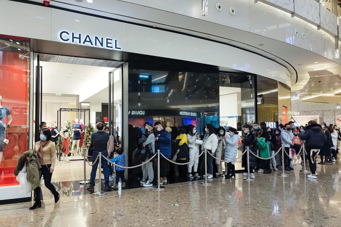 SHANGHAI, CHINA - DECEMBER 31: Customers line up to enter a Chanel store at IFC Mall on New Year's E...
