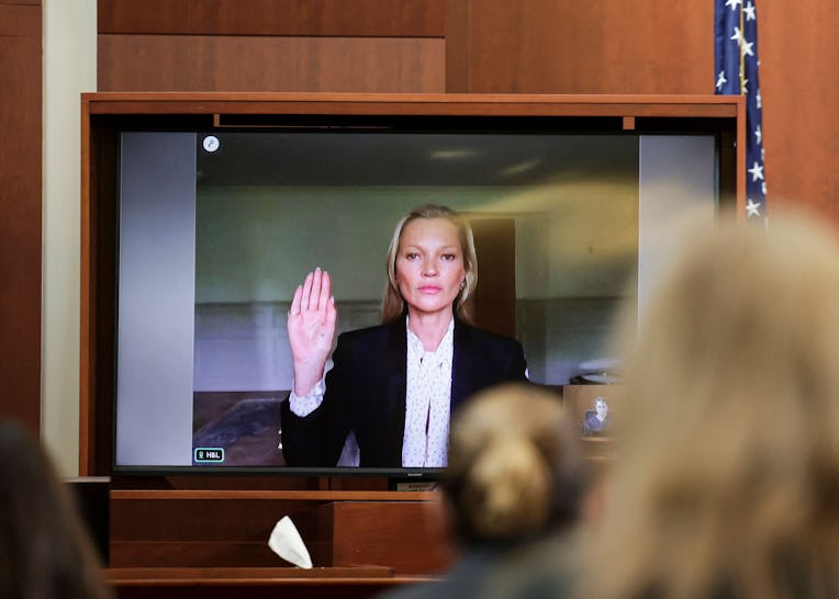 TOPSHOT - Model Kate Moss is sworn in via video link at the Fairfax County Circuit Courthouse in Fai...