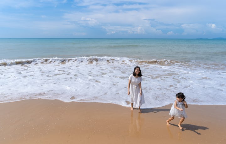 Mother and daughter happiness in beach on sunny morning. Travel discover sea of Phuket, Krabi, South...