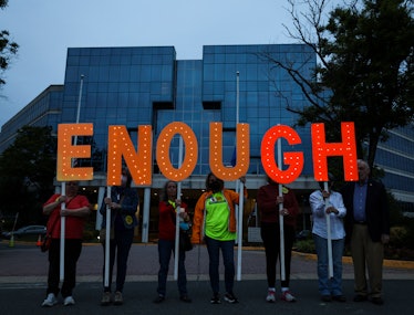 Gun-control advocates hold a vigil outside of the National Rifle Association (NRA) headquarters Kevi...