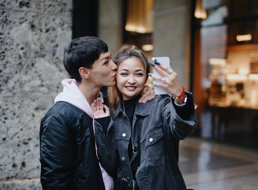 Happy couple taking selfie for social media