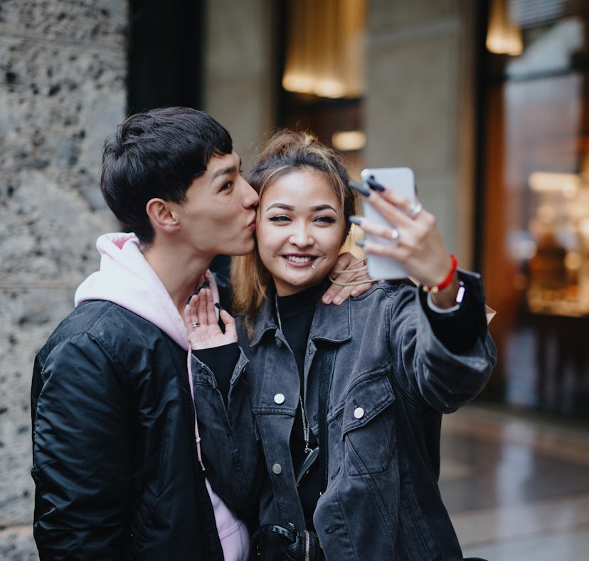 Happy couple taking selfie for social media