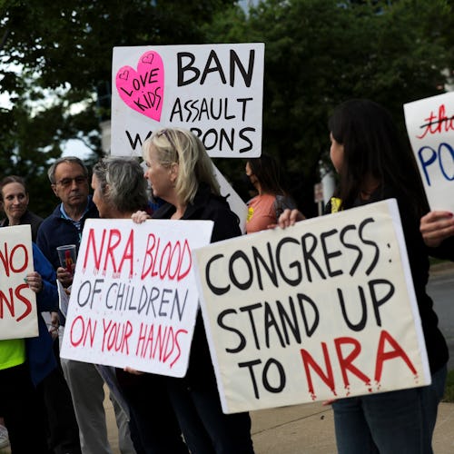 FAIRFAX, VIRGINIA - MAY 25: Gun-control advocates hold a vigil outside of the National Rifle Associa...