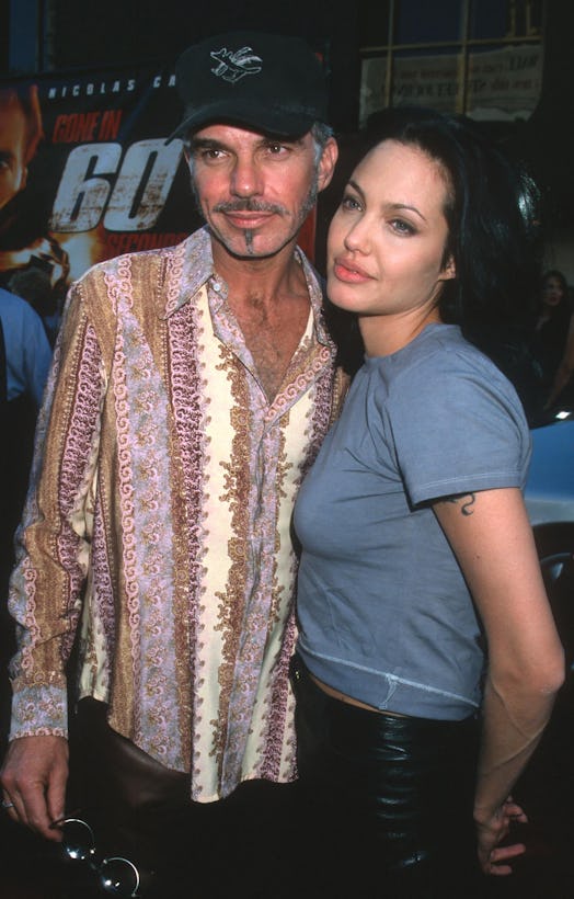 Billy Bob Thornton and Angelina Jolie pose side by side. He's wearing a patterned shirt and a baseba...