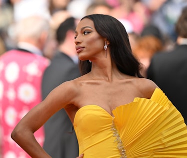 Jasmine Tookes at the screening of Top Gun : Maverick at the Cannes Film Festival in a yellow gown a...