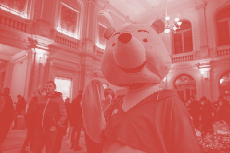 PRZEMYSL, POLAND - 2022/03/05: A volunteer is dressing up in Winnie the Pooh costume to entertain yo...