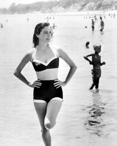 Actress Ava Gardner on the beach in a swimsuit