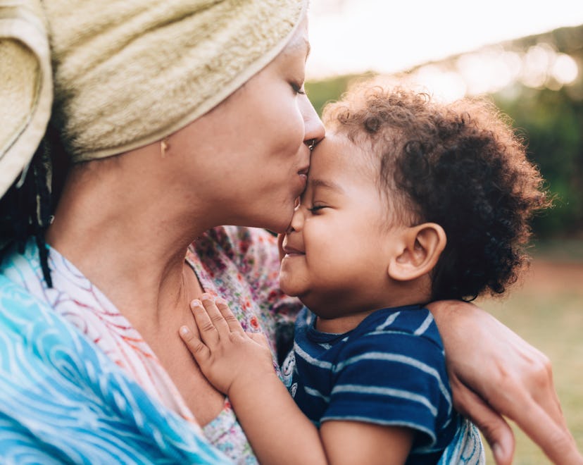 mother's day quotes to celebrate new mom, mom kissing baby on forehead