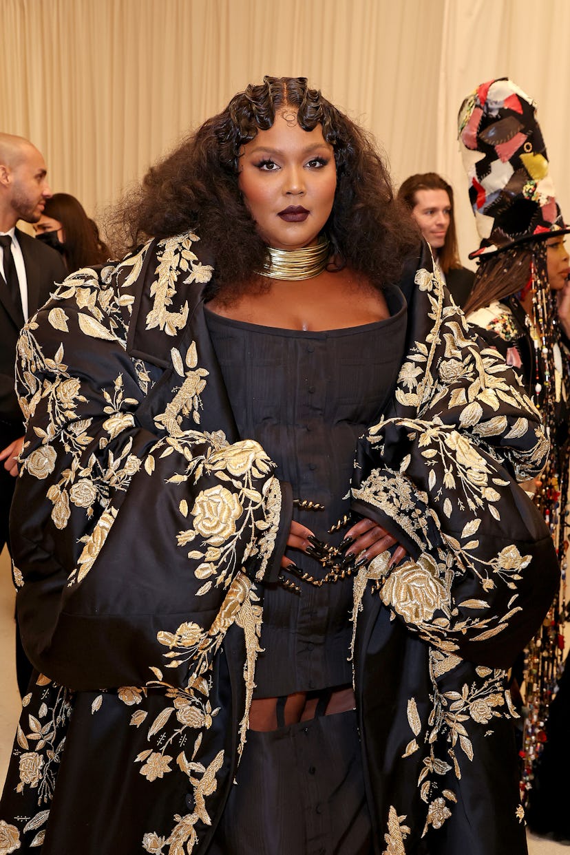 Lizzo wears a deep dark lipstick with matching smoky eye at the 2022 Met Gala Celebrating “In Americ…