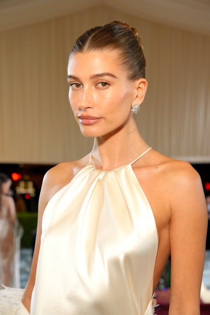 Hailey Bieber with glowing highlight on her cheekbones at The 2022 Met Gala Celebrating "In America:...