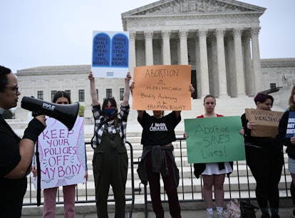 Pro-choice demonstrators hold signs in front of the US Supreme Court in Washington, DC, on May 3, 20...