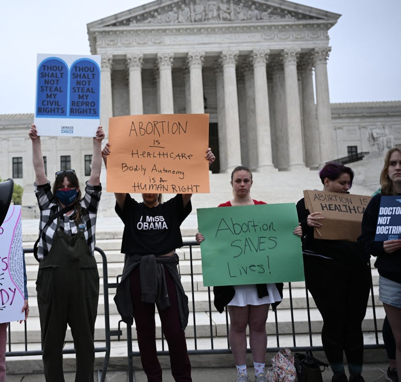 Pro-choice demonstrators hold signs in front of the US Supreme Court in Washington, DC, on May 3, 20...