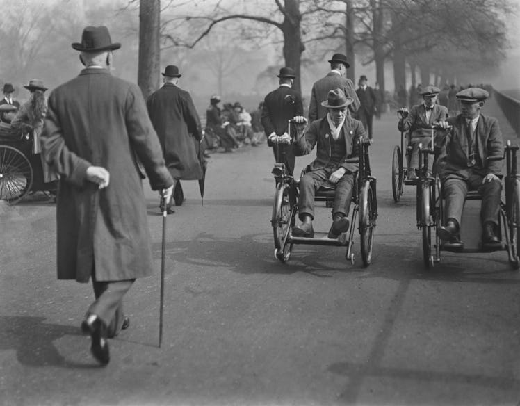 Three disabled veterans of World War I using hand-cranked wheelchairs on Rotten Row in Hyde Park, Lo...