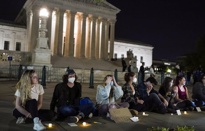 A crowd gathers outside the Supreme Court on Monday night after a purported leak says that Roe vs. W...