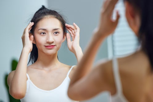 woman looking at herself in the mirror