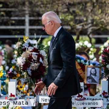 US President Joe Biden pays respect at a makeshift memorial outside of Robb Elementary School in Uva...