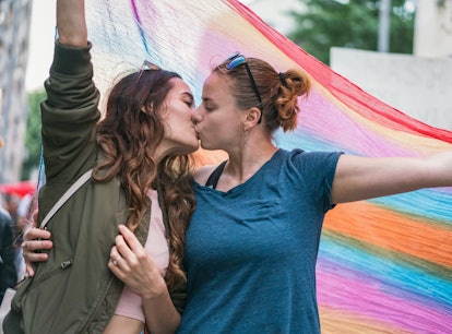 A female couple marching with the street parade need Pride Month 2022 captions for Instagram.