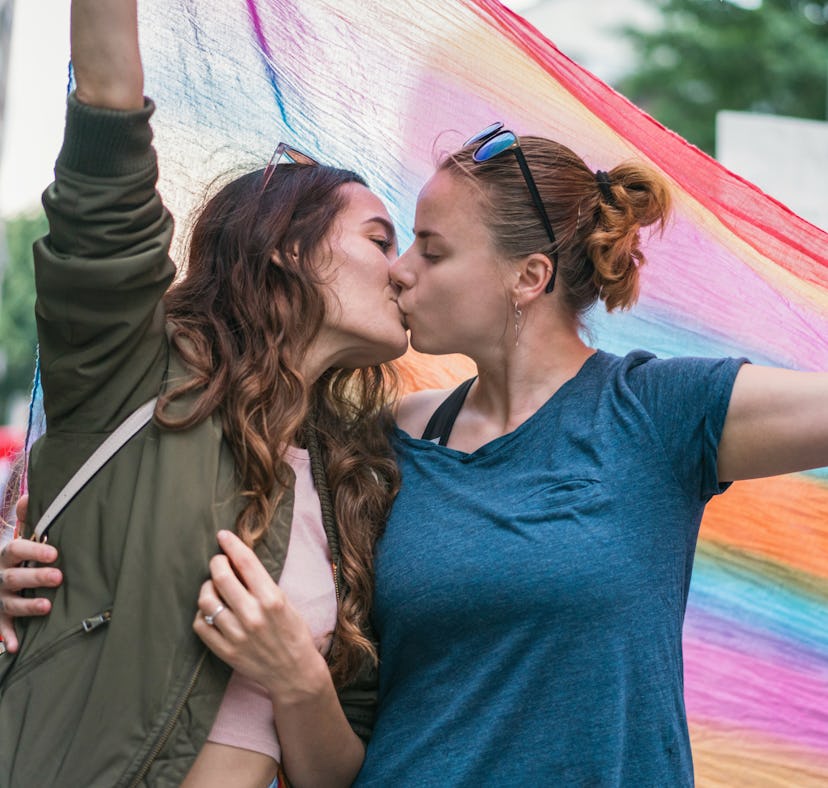 A female couple marching with the street parade need Pride Month 2022 captions for Instagram.