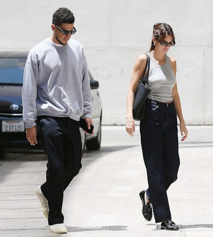 Kendall Jenner and Devin Booker spotted out wearing coordinating outfits with gray tops and dark pan...