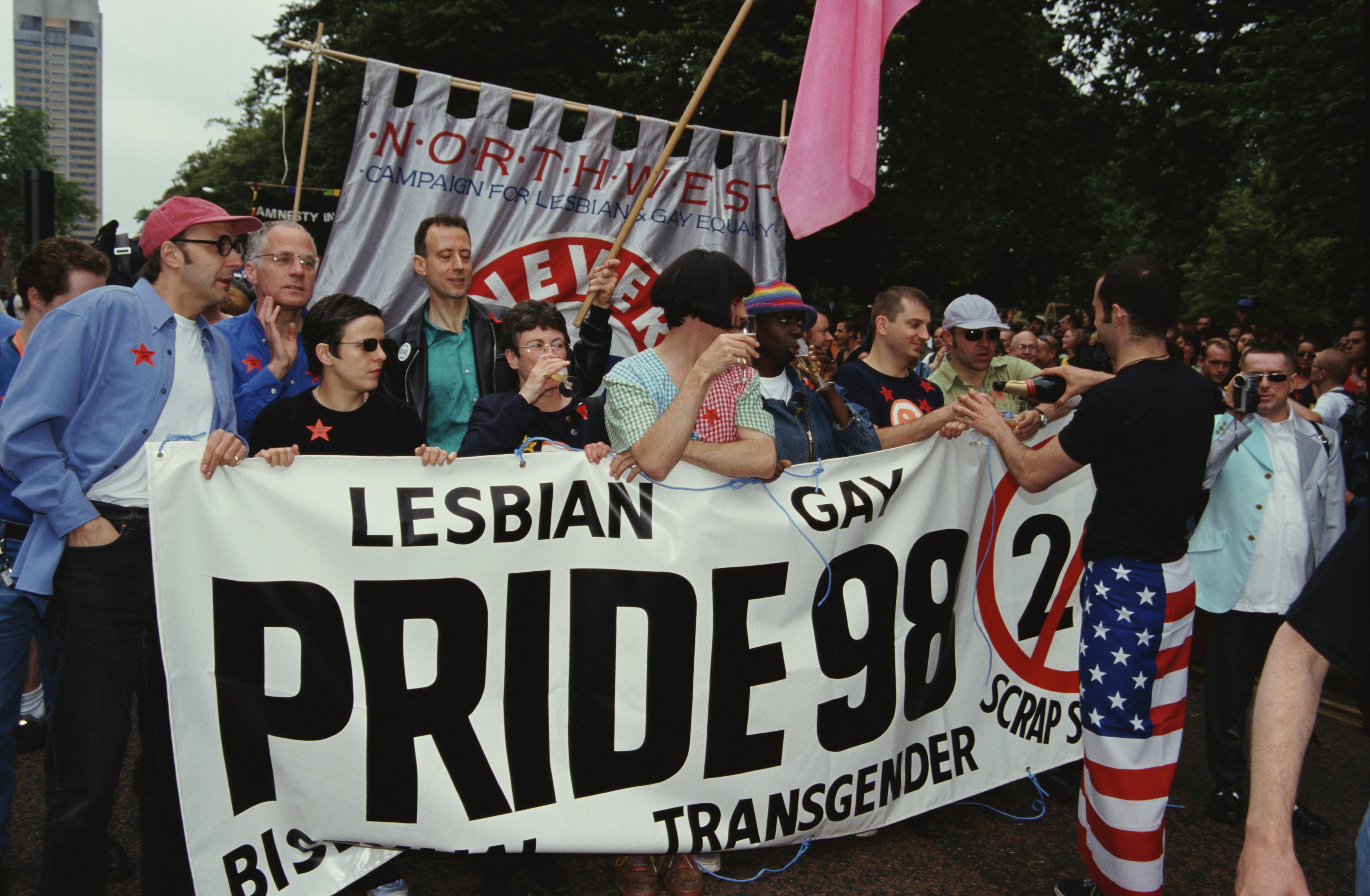 Activist Peter Tatchell and comedian Rhona Cameron carrying a large protest sign at London Pride in &hellip;